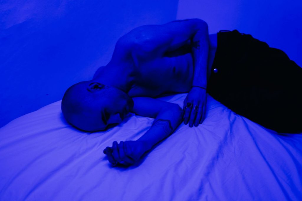 Mężczyzna leżący na błękitnym łóżku