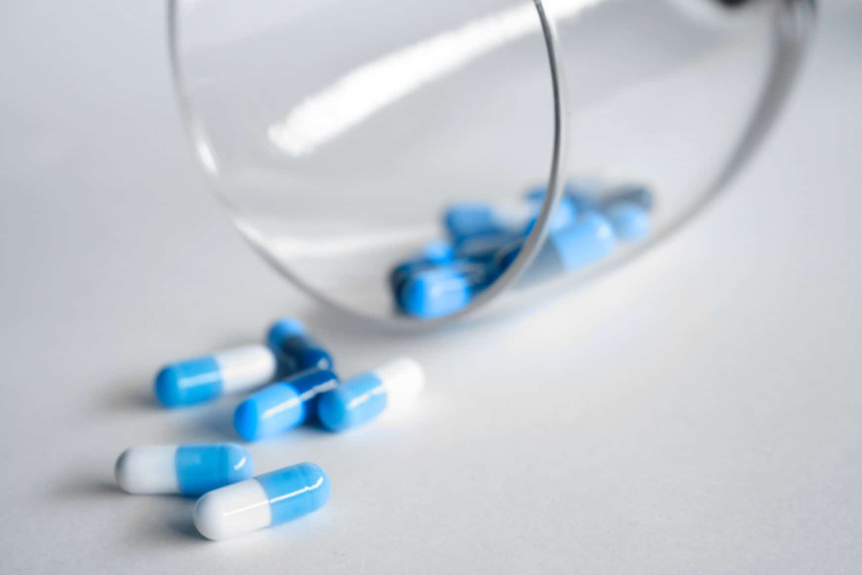 Białe i niebieskie tabletki na stole